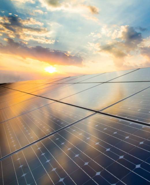 Photovoltaic modules on the background of sunset and cloudy sky